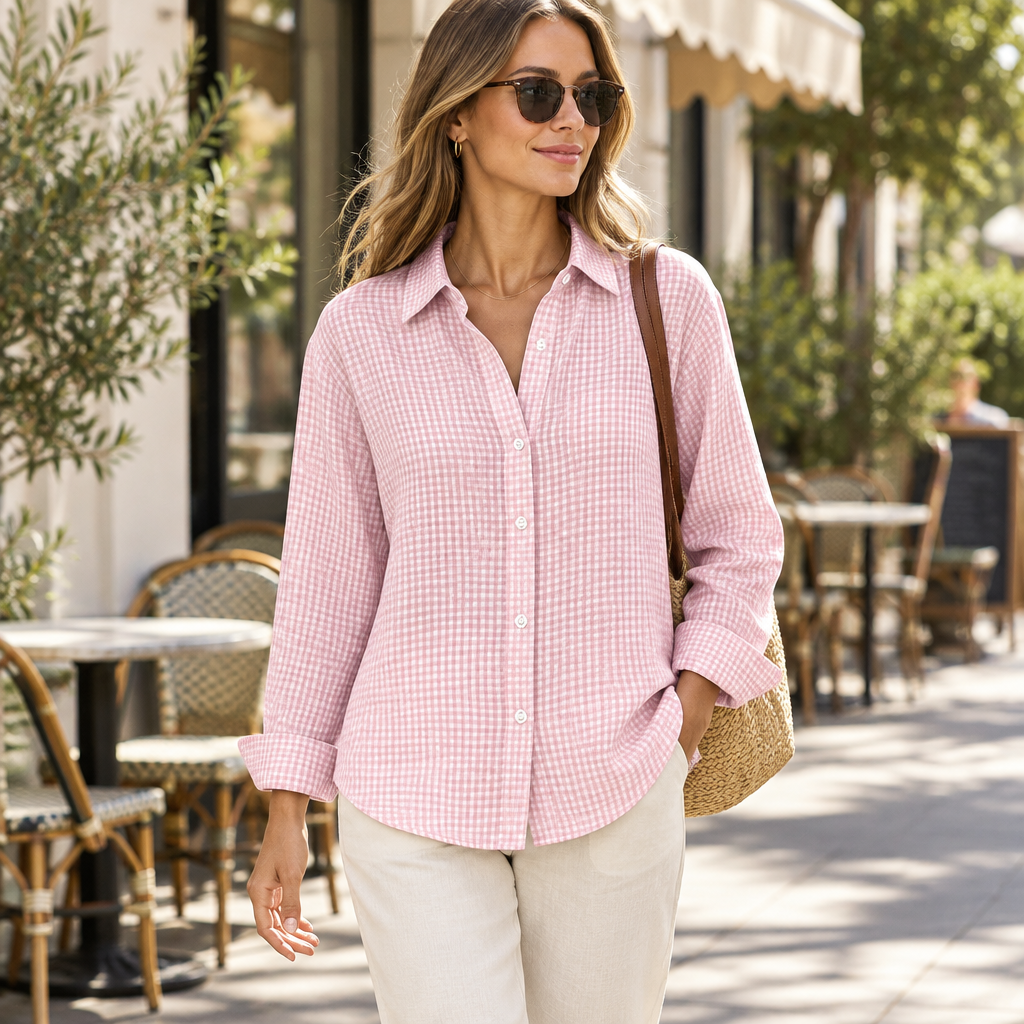 Pink plaid button-up shirt on a slim adult model, cafe