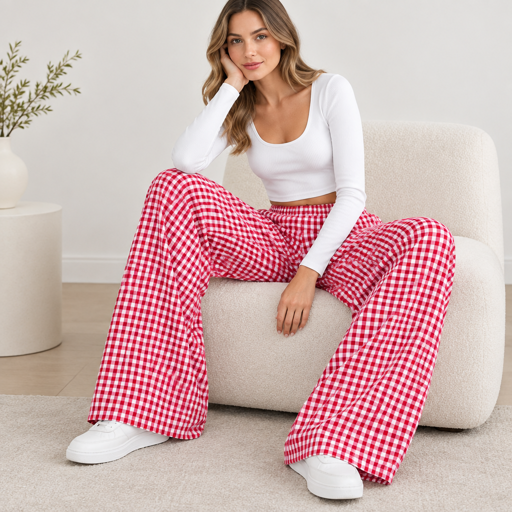 Red plaid wide-leg casual pants in a seated editorial pose