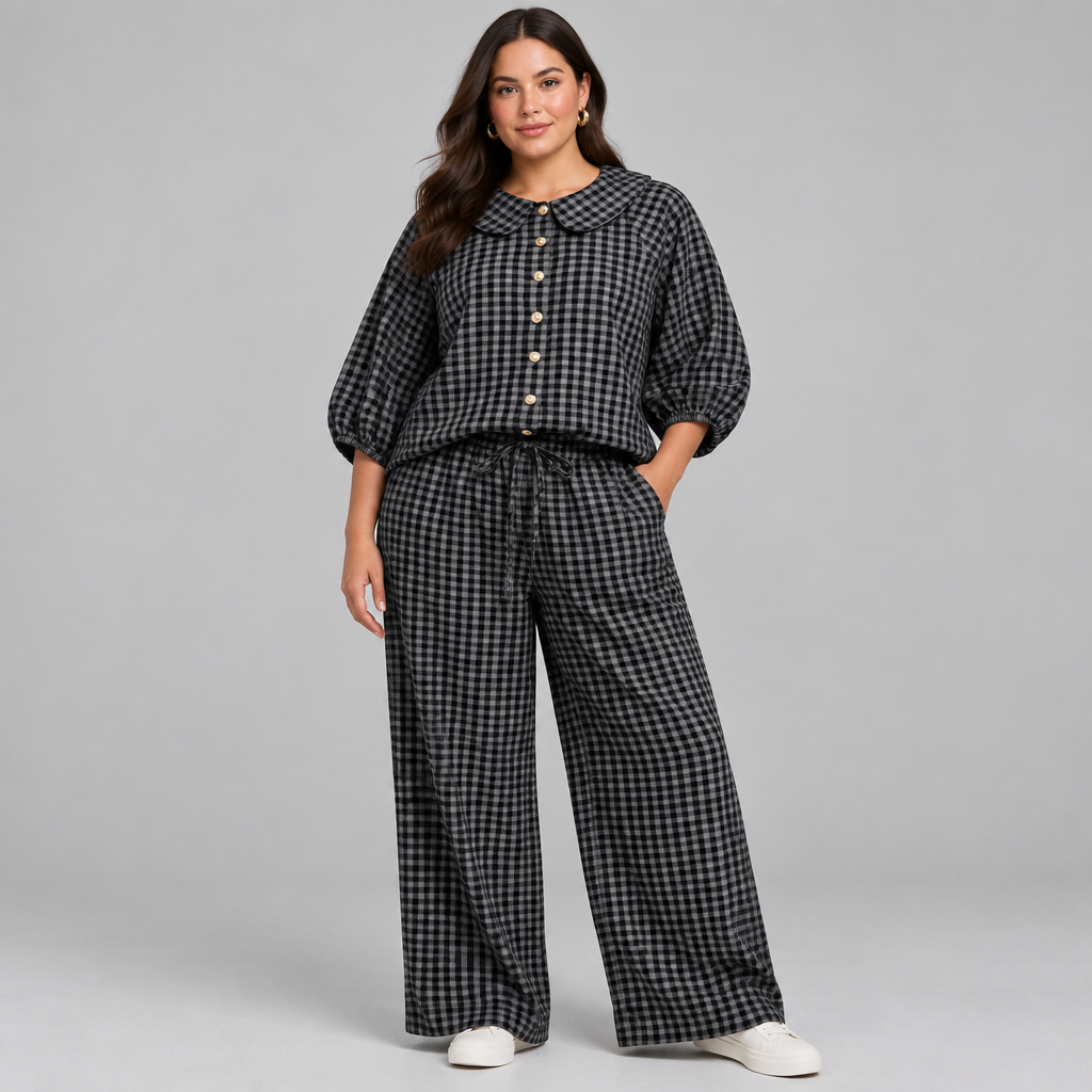 Black plaid button-up shirt and matching pants set in a studio view